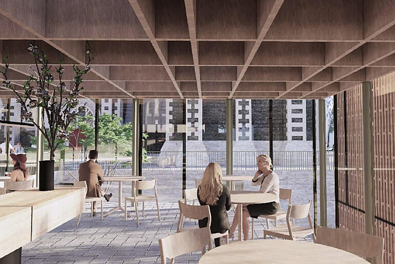 Visitors sit in the airy light-filled cafe with an outlook on the historic buildings that forms part of the new Cathedral Quarter.