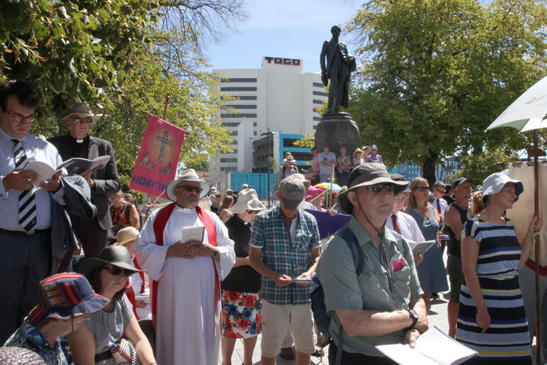Banner-carrying Anglicans gather in Cathedral Square. Banner-carrying Anglicans gather in Cathedral Square.