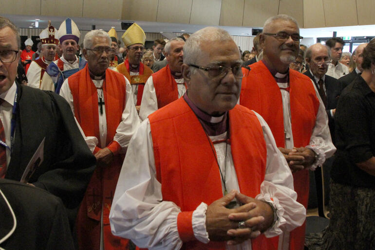 Bishop 'Afa Vaka and Bishop Henry Bull lead a line of bishops as they process into the ordination service at Christchurch Boys' High auditorium.