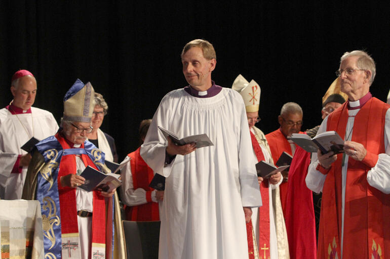 Bishop Brian Carrell (right) presents his son Peter Carrell to be ordained bishop. 