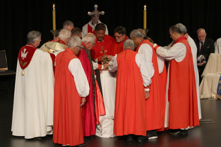 Bishops encircle Peter to ordain him bishop in the laying on of hands. Bishops encircle Peter to ordain him bishop in the laying on of hands.
