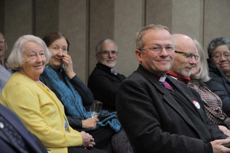 Retired Family Care Centre Director Catherine Goodyear (left in yellow) joins Bishop of Dunedin Steven Benford at the launch of 'Southern Service'.