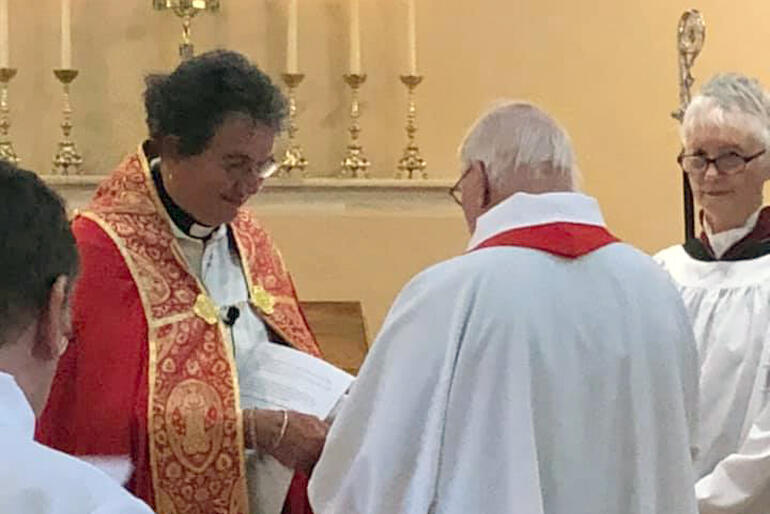 Representatives of S. Peter's Cathedral bring gifts of welcome to the new Dean.