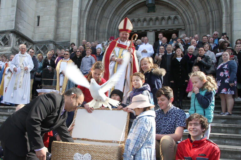 Another of the 25 doves fly from the cathedral steps. Another of the 25 doves fly from the cathedral steps.