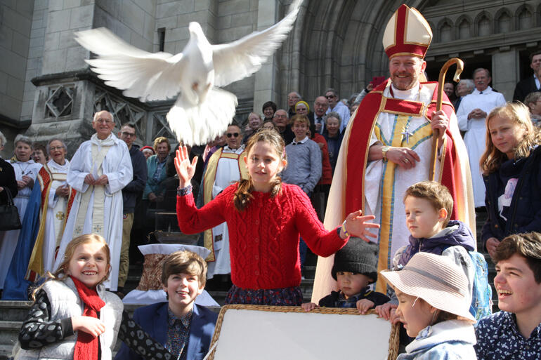 Bishop Steven looks on as Theodora Clarke-Wallace releases a dove following the Diocese of Dunedin's 150th celebration at St Paul's Cathedral Dunedin. Bishop Steven looks on as Theodora Clarke-Wallace releases a dove following the Diocese of Dunedin's 150th celebration at St Paul's Cathedral Dunedin.