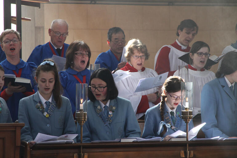 Members of St Hilda's, St Paul's Cathedral and St John's Roslyn choirs join in song.