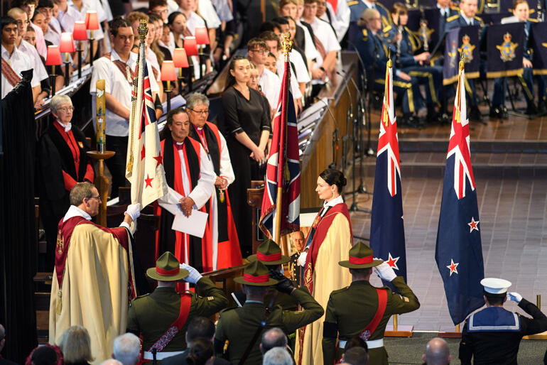 Dean David Rowe and Canon Precentor Katie Lawrence receive and place the flags of the NZ Defence Force. Dean David Rowe and Canon Precentor Katie Lawrence receive and place the flags of the NZ Defence Force.