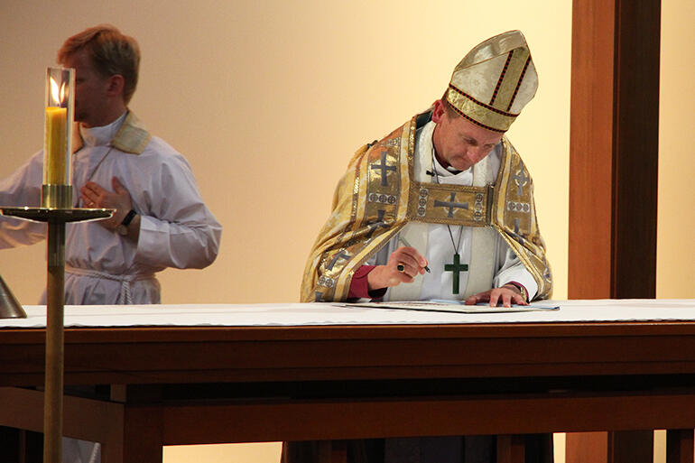 Bishop Ross Bay signs the Consecration Charter on the high altar. Bishop Ross Bay signs the Consecration Charter on the high altar.
