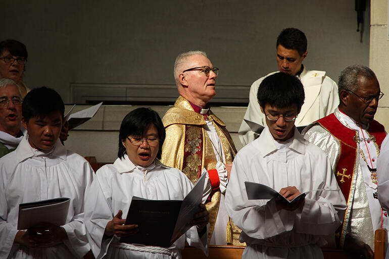 That's Archbishop Philip Freier, Primate of Australia, in the spotlight - with Archbishop George Takeli at right.