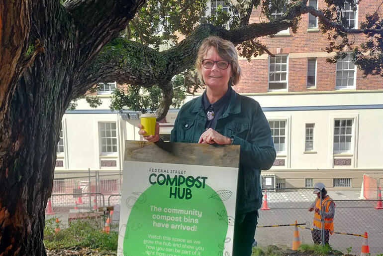 St Matthew-in-the-City Priest for Community Engagement Rev Cate Thorn shows off the new composting hub signage.