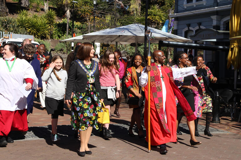 Bishop Steve greets Nelson people as he sets forth into the city.