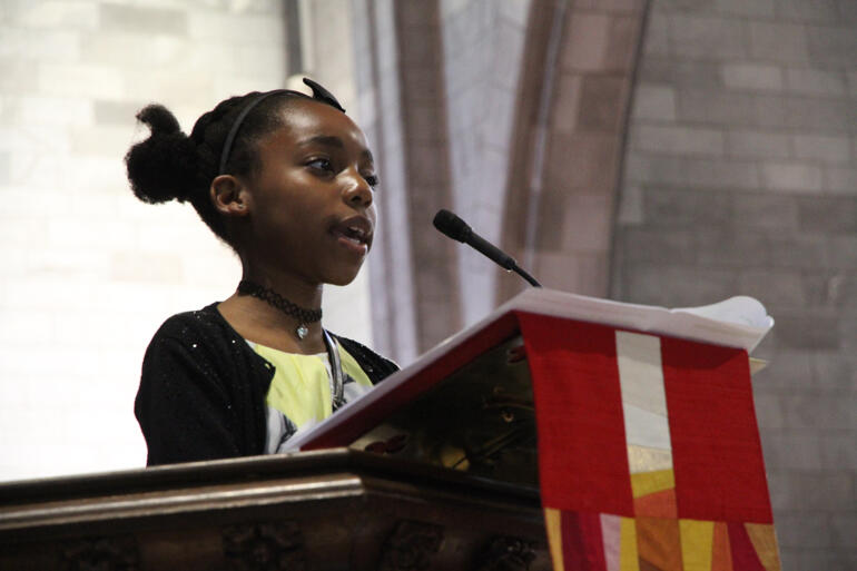 Bishop Steve's niece Zawadi Mwendwa reads from the Gospel of John. Bishop Steve's niece Zawadi Mwendwa reads from the Gospel of John.