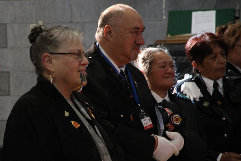 Kai karanga Jane du Feu of Te Āti Awa smiles her welcome to Bishop Steve following her formal call, as Nelson Māori wardens look on. Kai karanga Jane du Feu of Te Āti Awa smiles her welcome to Bishop Steve following her formal call, as Nelson Māori wardens look on.