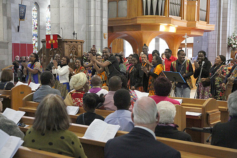 Kenyan family, friends and colleagues worship God in dance and Swahili song. Kenyan family, friends and colleagues worship God in dance and Swahili song.