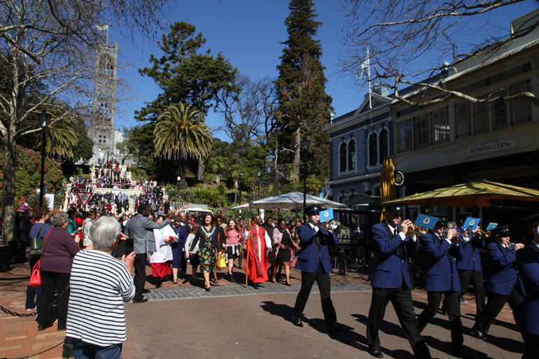 Nelson City Brass Band lead the Bishop and Mayor in procession along Nelson's Trafalgar Street as worshippers pour down the Cathedral steps. Nelson City Brass Band lead the Bishop and Mayor in procession along Nelson's Trafalgar Street as worshippers pour down the Cathedral steps.