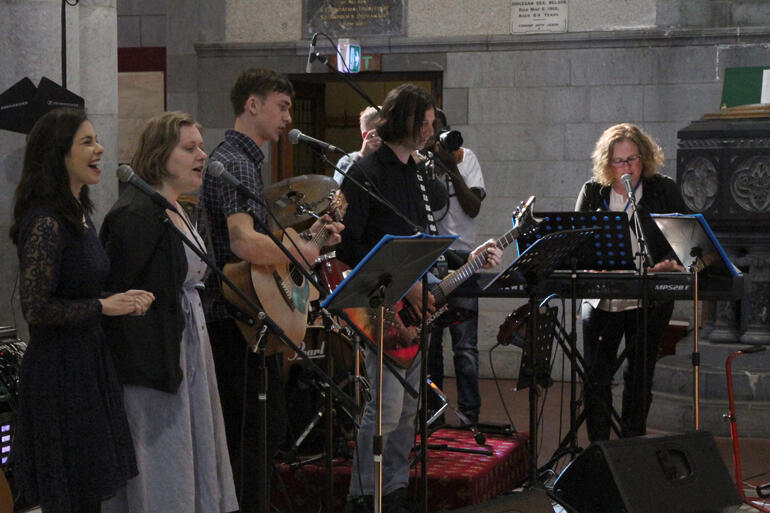 Nelson's worship band lead the congregation in joyous worship.