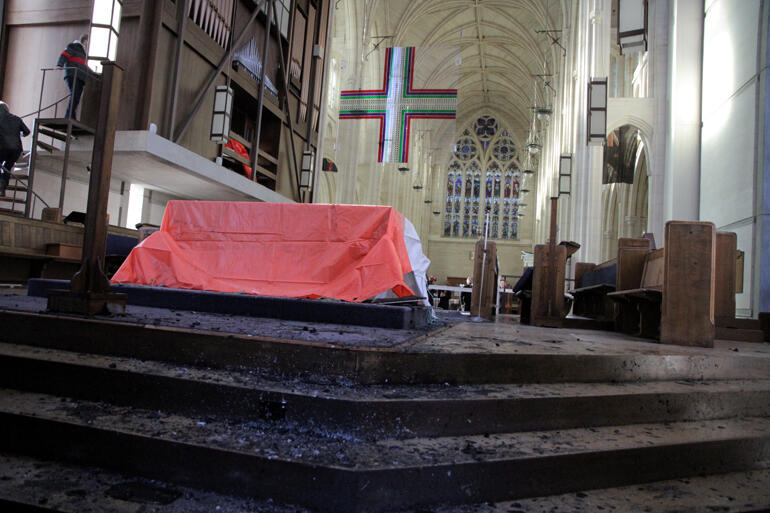 Ash litters the sanctuary where flaming embers scorched holes into the carpet, cork tile and wooden flooring. Ash litters the sanctuary where flaming embers scorched holes into the carpet, cork tile and wooden flooring.