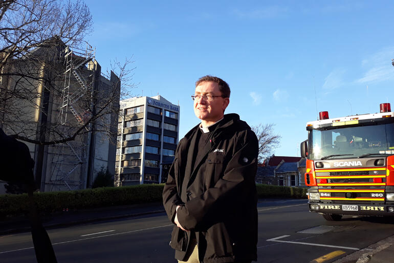 Dean of Dunedin Very Rev Tony Curtis on the scene of a fire at St Paul's Cathedral this morning already hours into his day after a 4.20am start.