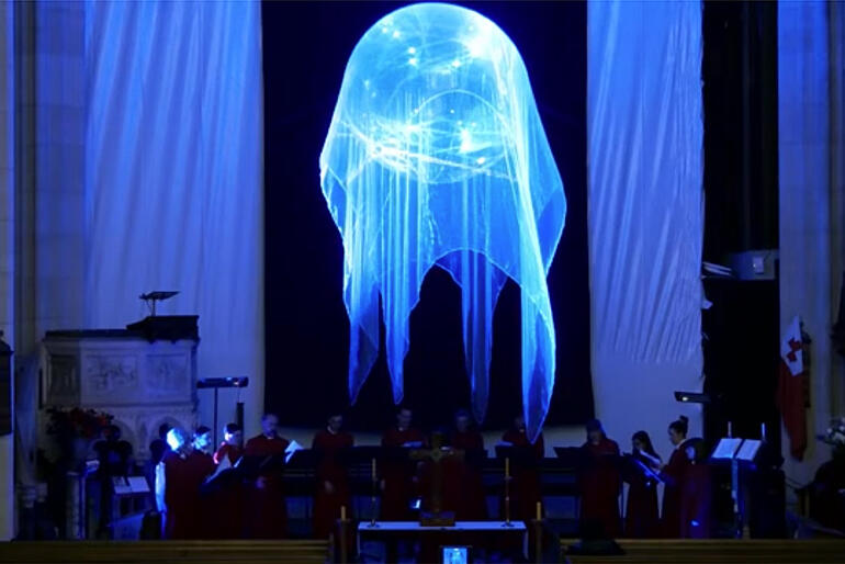 Members of St Paul's Cathedral choir sing Ēriks Ešenvalds’ “Stars” while illuminated by the installation. Members of St Paul's Cathedral choir sing Ēriks Ešenvalds’ “Stars” while illuminated by the installation.