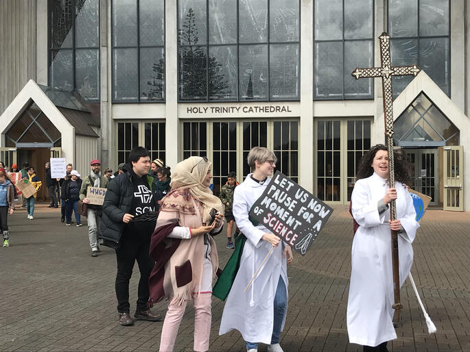 Climate strike supporters depart from Holy Trinity Cathedral led by Rev Sarah West and Jessica Hughes with Auckland's diocesan Melanesian cross. Climate strike supporters depart from Holy Trinity Cathedral led by Rev Sarah West and Jessica Hughes with Auckland's diocesan Melanesian cross.