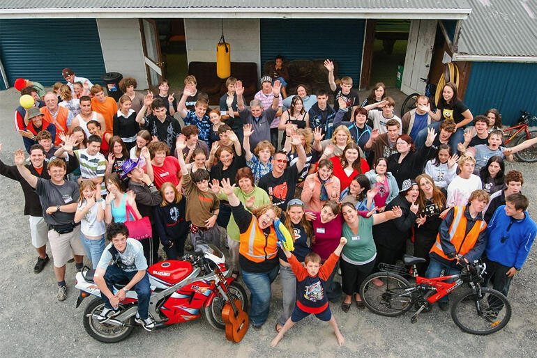 Nicky and Tim Mora with a group at 'The Shed' back in 2005, the Greymouth-based Anglican-founded youth ministry that turns 25 this year.
