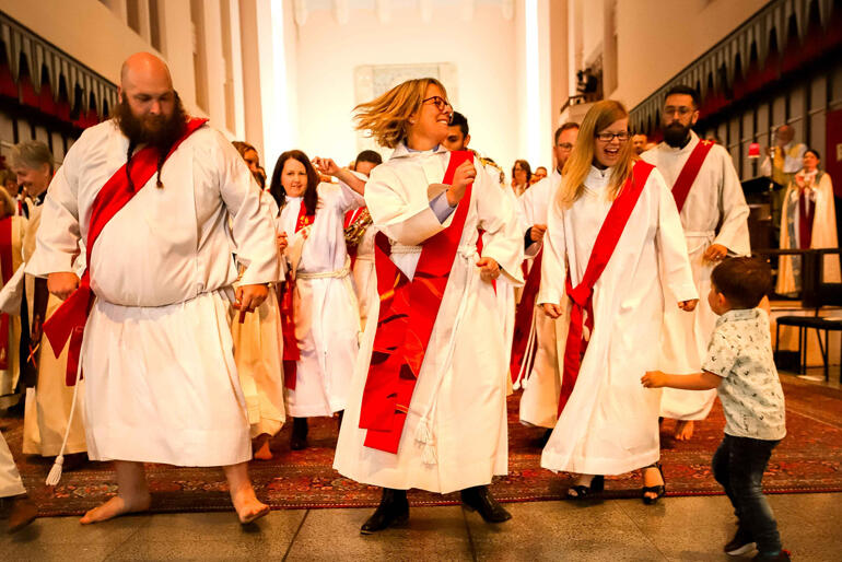 Rev Luke Paynter, Rev Kath Bier, and Rev Emily Spence lead a surprise dance flash mob of new deacons and priests.