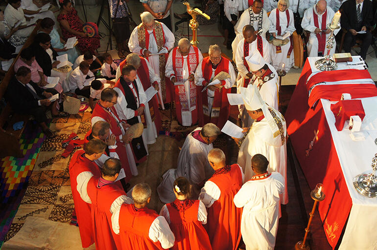 The bishops present gather around the bishop-elect - invoke the Holy Spirit, and prepare to ordain him.