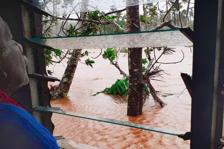 A view out the window at St Paul's Anglican Church Naviavia shows the extent of flooding across a wide area.