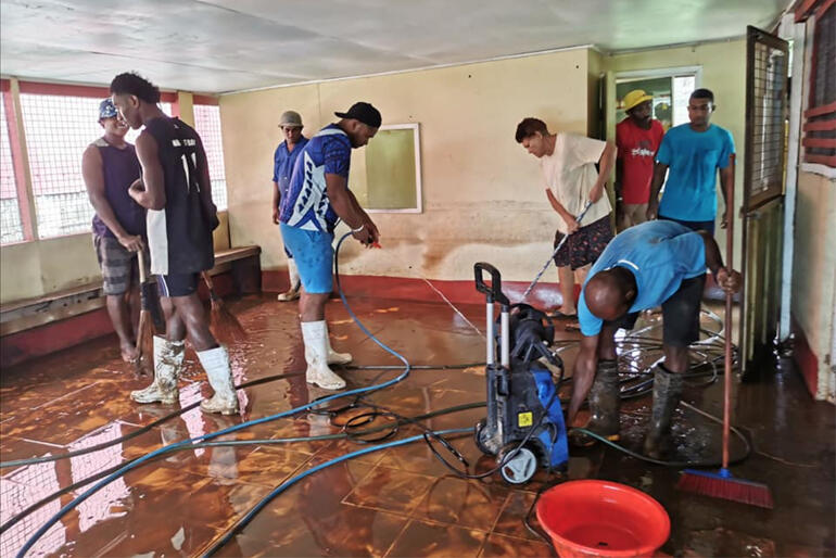 Volunteers at St Thomas Labasa begin cleaning up the layers of mud and silt left behind by last weekend's flooding. Photo: Sairusi Kadi Kaiwaidau