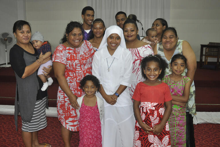 New Moana Community of St Clare Novice Miliva stands with her proud family supporters at her clothing service in St Christopher's Church, Naulu, Fiji. New Moana Community of St Clare Novice Miliva stands with her proud family supporters at her clothing service in St Christopher's Church, Naulu, Fiji.