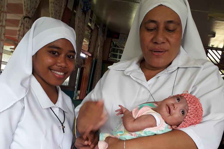 New Moana Community of St Clare postulant, Miliva Toariki smiles for the camera alongside Sr Kalolaine Tuinea'u and a new St Christopher's baby. New Moana Community of St Clare postulant, Miliva Toariki smiles for the camera alongside Sr Kalolaine Tuinea'u and a new St Christopher's baby.