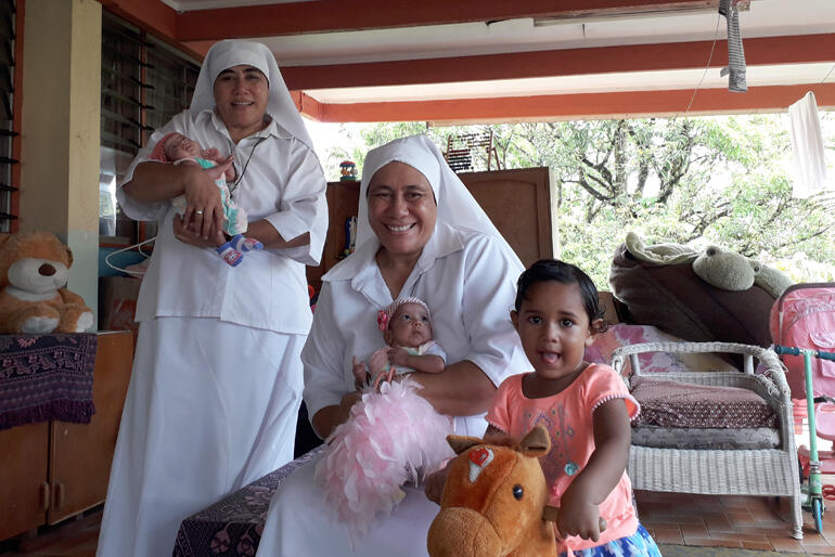 Sr Longo and Sr Kalolaine with two of the babies and a toddler who live at St Christopher's Home in Suva. Sr Longo and Sr Kalolaine with two of the babies and a toddler who live at St Christopher's Home in Suva.