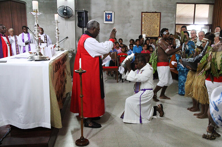 Archbishop George Takeli of Melanesia blesses the Bible, which is about to be read by Fr Harry Gereniu. Archbishop George Takeli of Melanesia blesses the Bible, which is about to be read by Fr Harry Gereniu.