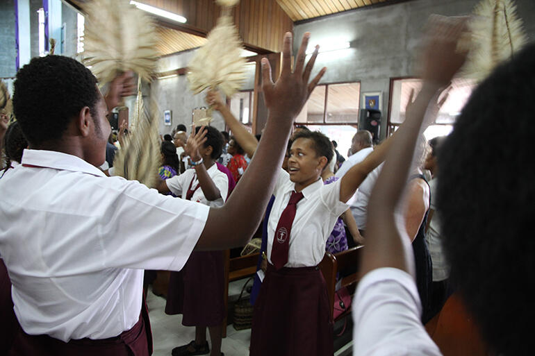 Students from Basden College flan'ked the central aisle during the recession, performing: 'Let there be Light!