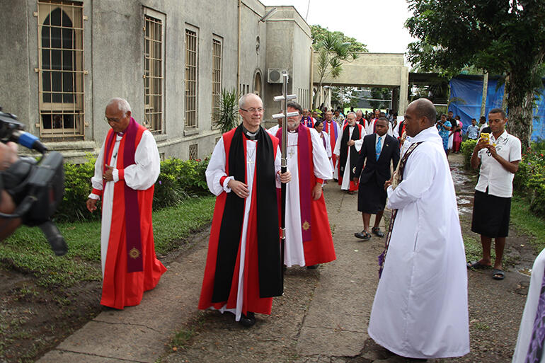 The Archbishop of Canterbury pauses to greet a well-wisher as he leaves the cathedral.