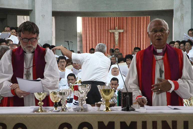 The Ven Chris Solomona, Archdeacon of Samoa, conducting the massed choir.