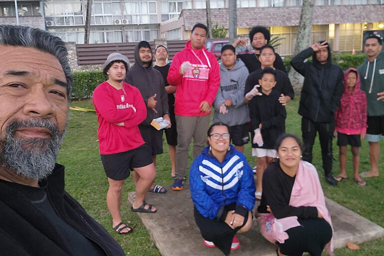 Fe'iloakitau Kaho Tevi snaps a selfie with a 'No Pelestiki' crew after a Season of Creation 2023 coastal clean-up.