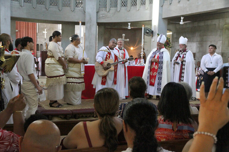 Archbishop Sione, flanked by wife Taina and daughter Fifita strikes the right chord as Pīhopatanga guests sing 'He Aroha'. Archbishop Sione, flanked by wife Taina and daughter Fifita strikes the right chord as Pīhopatanga guests sing 'He Aroha'.
