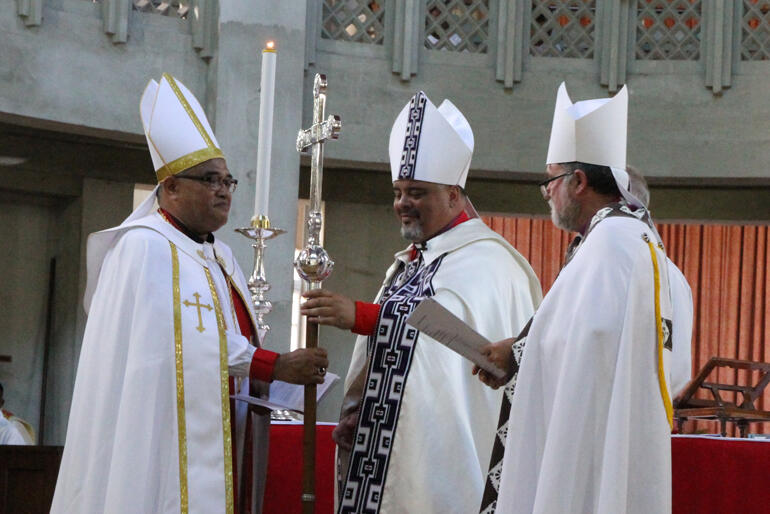 Archbishops Don and Philip hand their new fellow Archbishop the primatial cross. Archbishops Don and Philip hand their new fellow Archbishop the primatial cross.