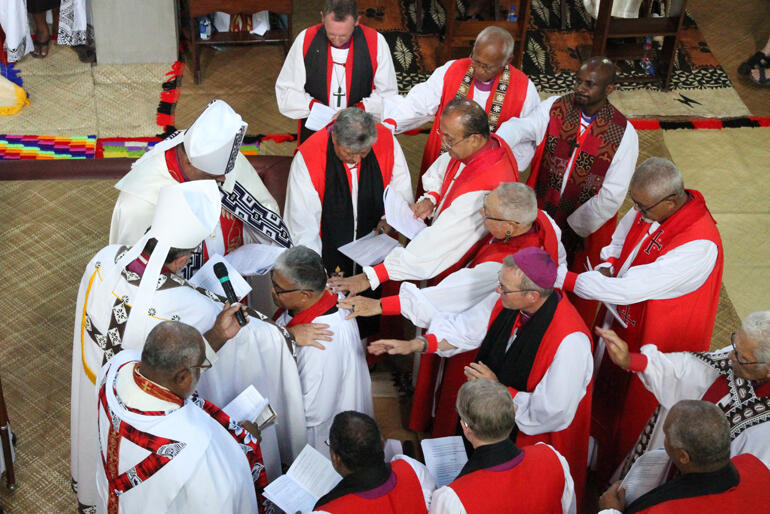 Bishops and Archbishops lay hands on Sione Uluilakepa in ordination to the episcopate. Bishops and Archbishops lay hands on Sione Uluilakepa in ordination to the episcopate.