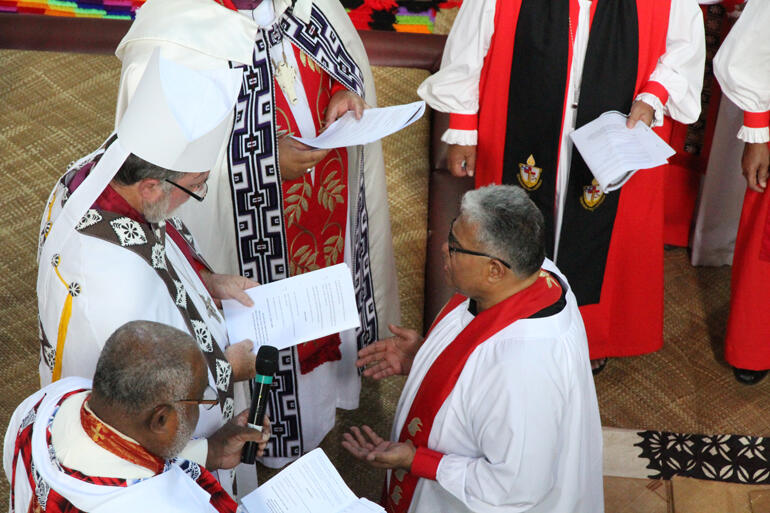 Fr Sione awaits the Holy Spirit as the assembly sings and prays.