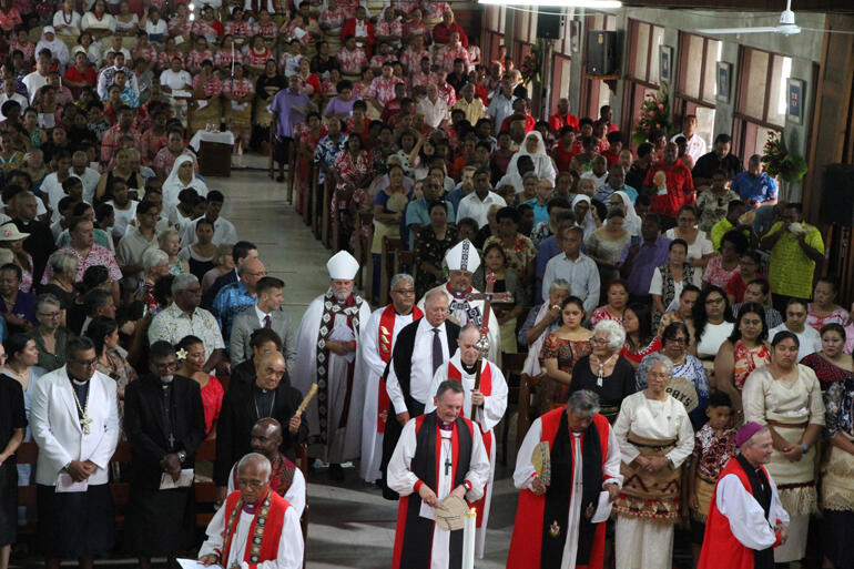 Fr Sione takes up the rear of the entry procession in readiness for his new role. Fr Sione takes up the rear of the entry procession in readiness for his new role.