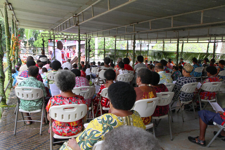 Hundreds watch from an additional pavillion as Dean of Suva Orisi Vuki welcomes all to Holy Trinity Cathedral.
