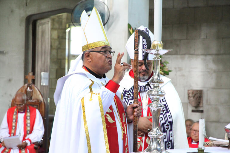 Newly ordained +Sione gives the blessing to conclude Saturday's service. Newly ordained +Sione gives the blessing to conclude Saturday's service.