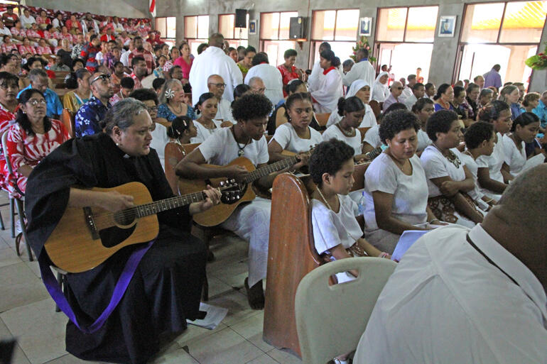 Rev Sepiuta Hala'api'api accompanies guitarists and singers from St Christopher's Home during Communion. Rev Sepiuta Hala'api'api accompanies guitarists and singers from St Christopher's Home during Communion.