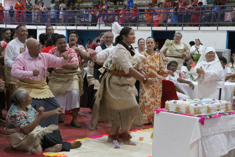 Tongan Anglicans jump to their feet in support of Fifita Uluilakepa's ceremonial dance.