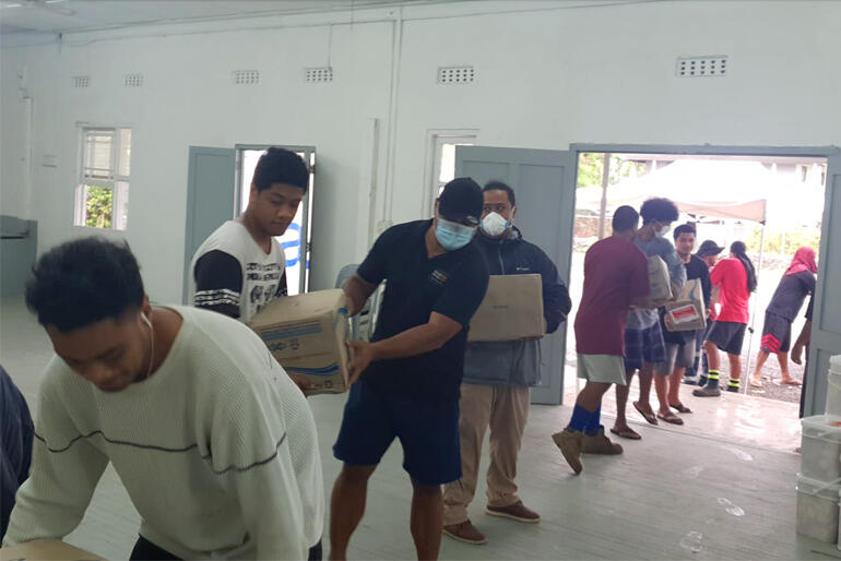 A team installs emergency boxes indoors during the Tongan Anglican Church's first distribution of essential supplies following this year's eruption. A team installs emergency boxes indoors during the Tongan Anglican Church's first distribution of essential supplies following this year's eruption.