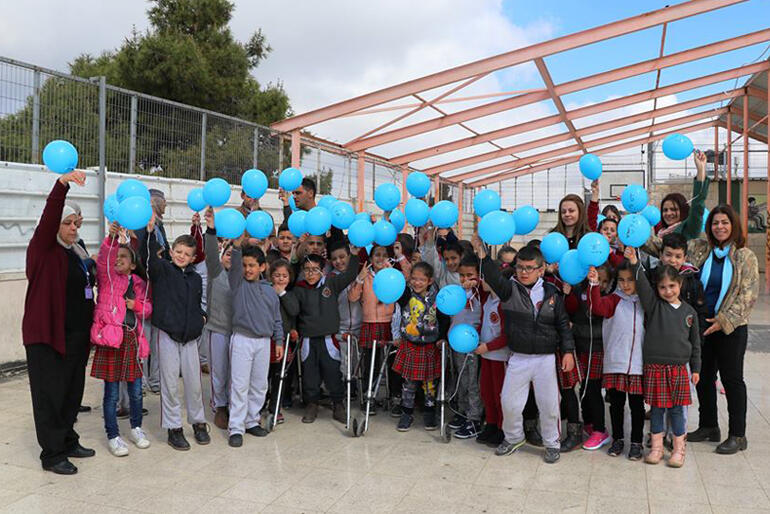Staff and children line up for a picture at Jerusalem's Princess Basma Centre for children with disabilities.