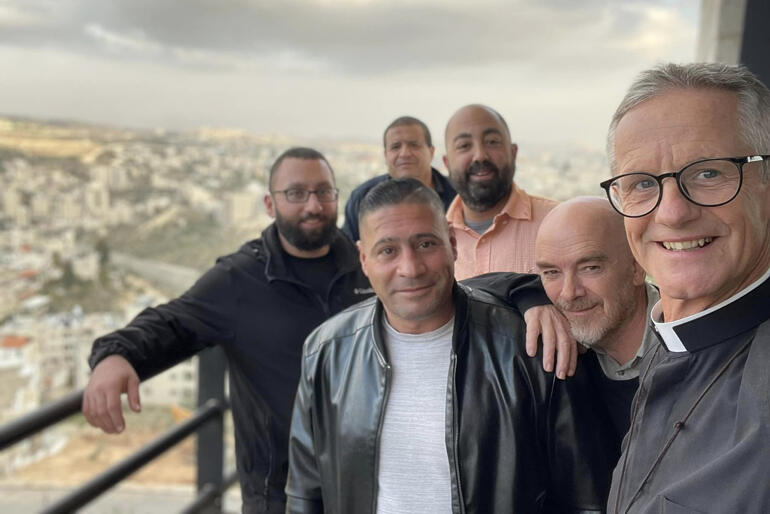 Dean Richard Sewell & St George's staff grab a selfie overlooking Jerusalem where they welcome international study pilgrims.
