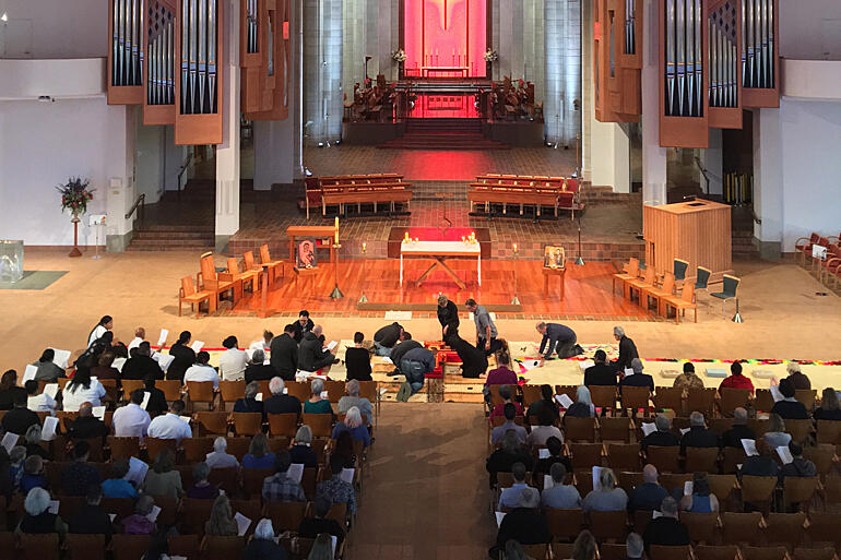 Worshippers gather around the cross during Brother Matthew's pilgrimage to Holy Trinity Cathedral Auckland.